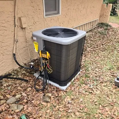Air conditioner being serviced with refrigerant gauges connected